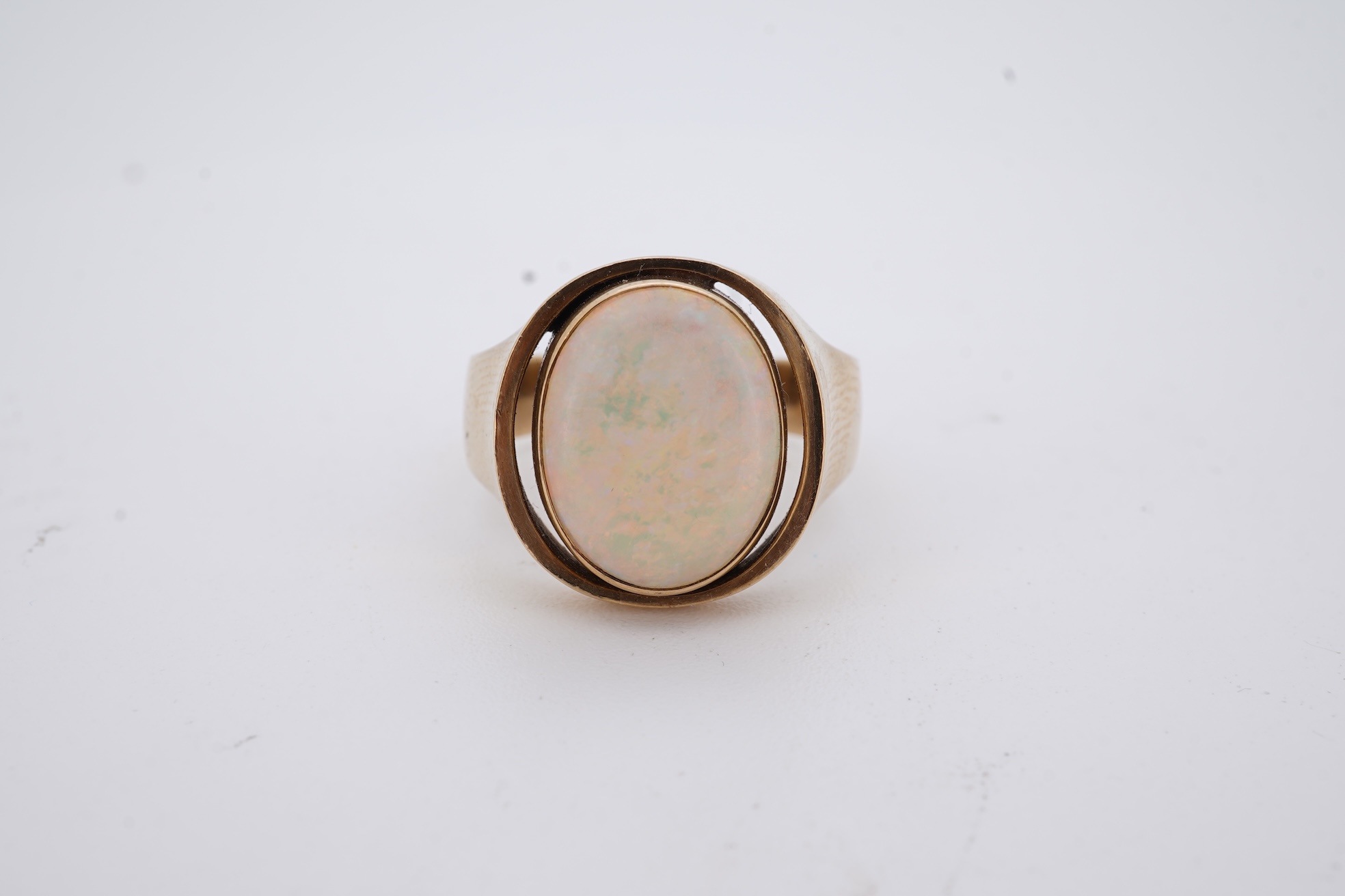 A 9ct and single stone cabochon white opal set ring, size K/L, gross weight 5 grams.